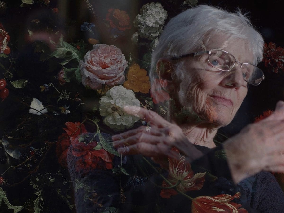 In this film still from the Look Imagine Move project from University of Cambridge Museums Dance with the Museum project, a dancer appears with her arm bent up in front of her, mingling with the impression of a painting from an art gallery